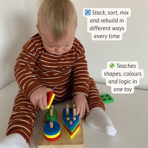 Child playing with colorful wooden building blocks on a light surface. 
