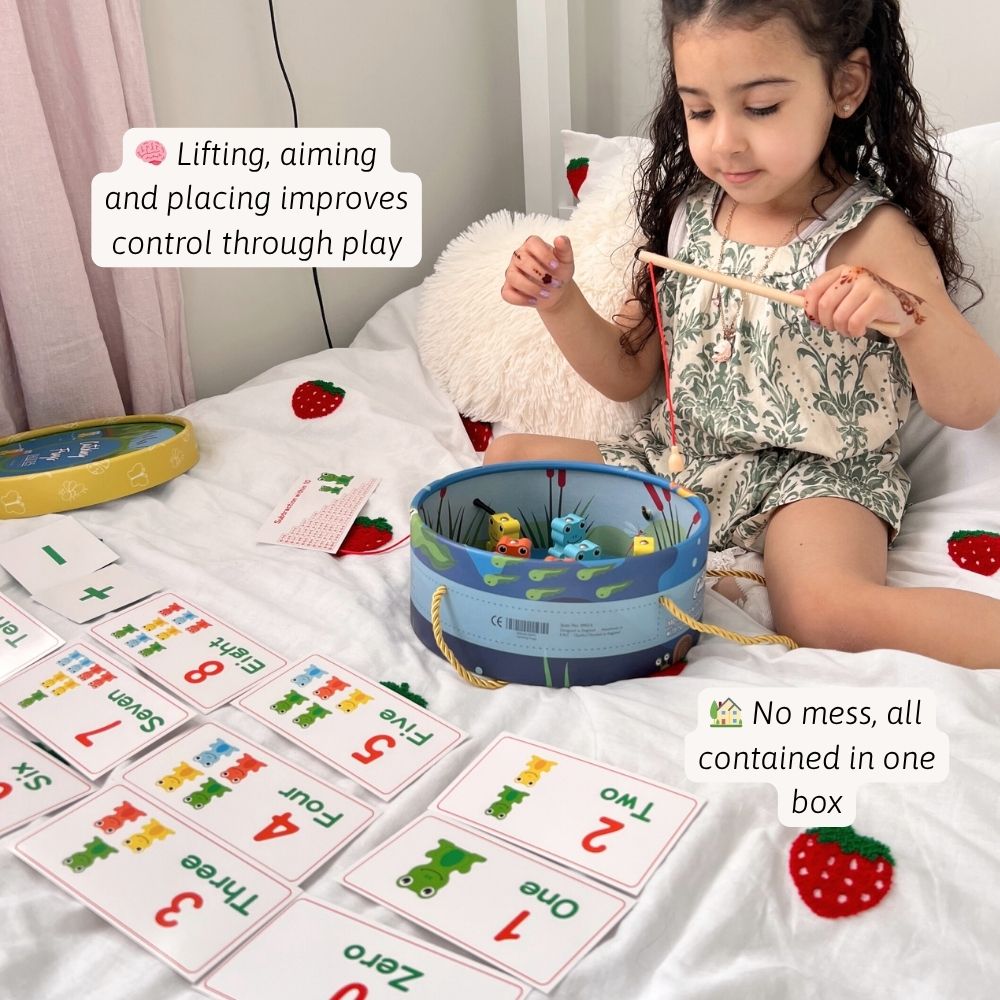 Child playing with educational toys and cards on a bed 