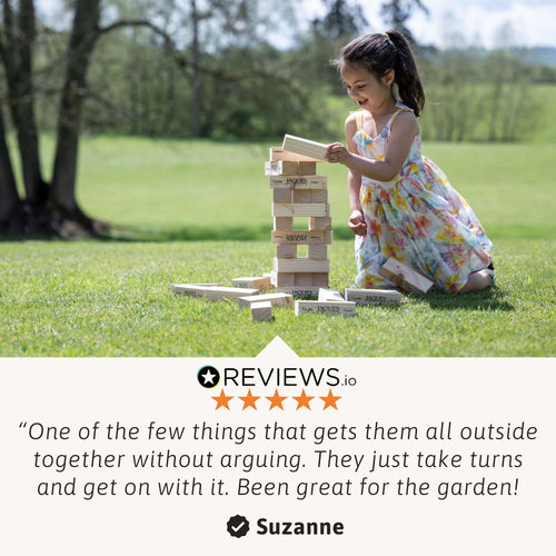 Child playing wooden tumble tower garden game with review quote overlay 