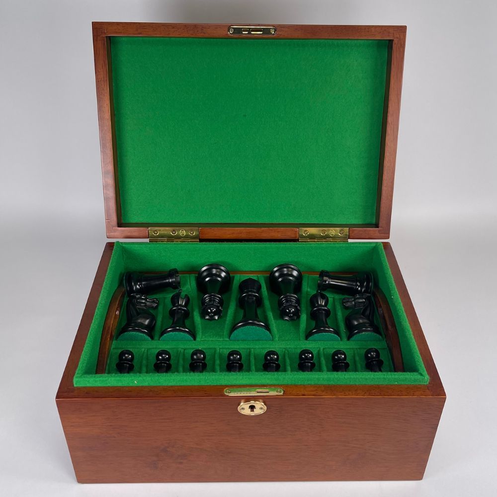 Wooden chess set with green felt interior on a white background 