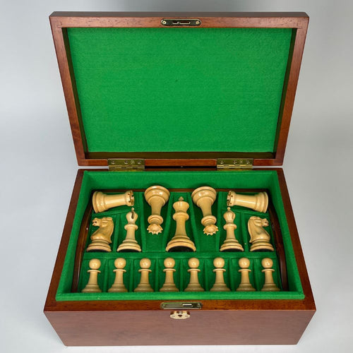 Wooden chess set with green felt interior on a white background 