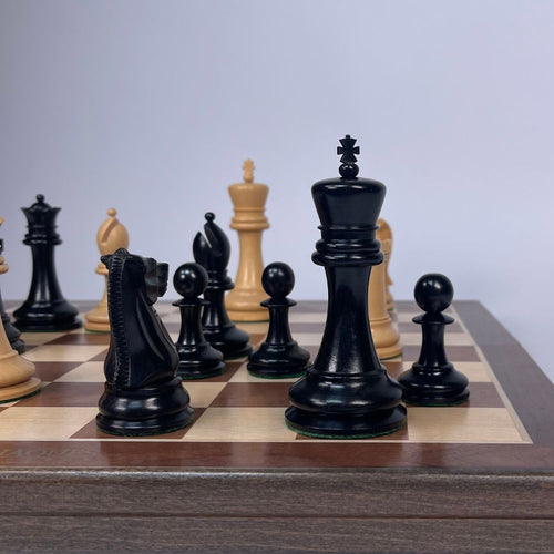 Close-up of chess pieces on a wooden chessboard with a light grey background  