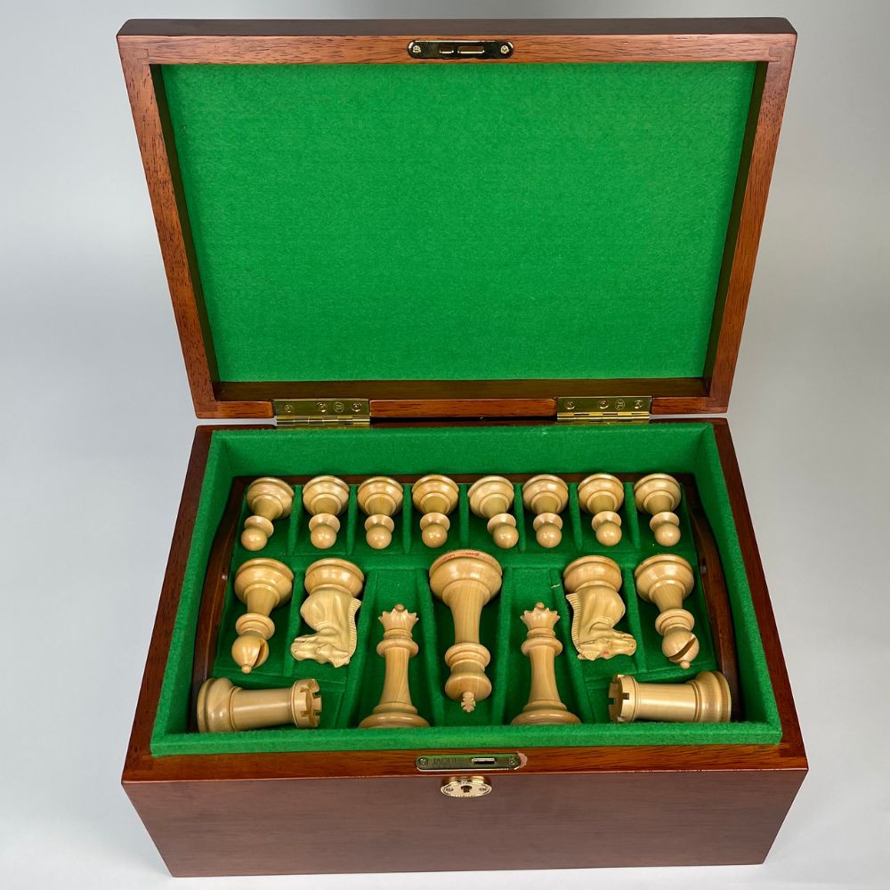 Chess set with pieces in a wooden box on a white background  
