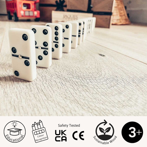 Set of dominoes on a wooden surface with safety and quality certification logos at the bottom. 