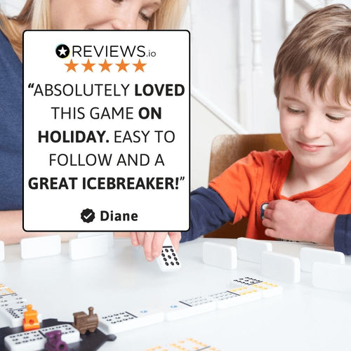 Child smiling while playing Mexican Train dominoes board game 