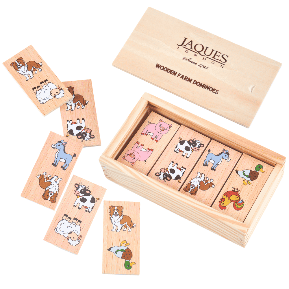 Wooden farm dominos game set by Jaques London, showing several animal-themed wooden tiles scattered beside an open wooden box containing the remaining tiles, with the lid shown above on a white background.