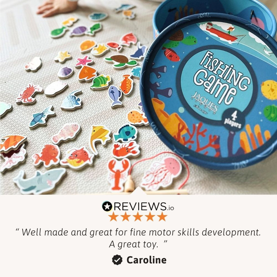 Fishing game with colourful fish pieces and a blue tin labelled 'Jacques Fishing Game' on a light surface. [fill]