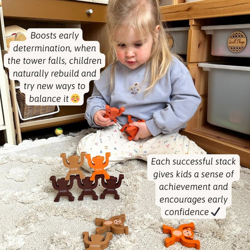 A child carefully balancing a monkey on top of the stack 