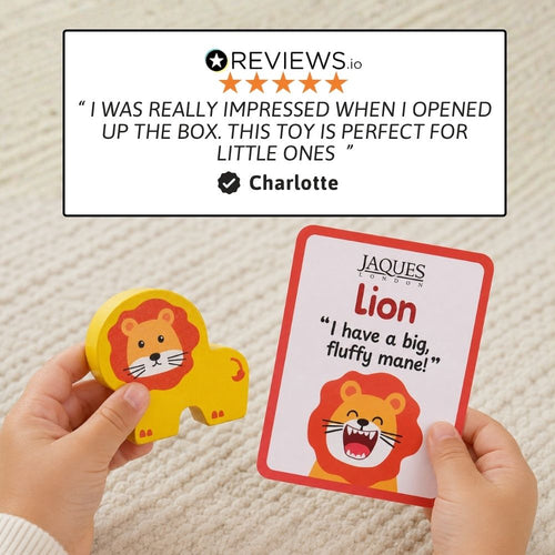 A person holds a yellow lion-shaped wooden toy and a red-bordered card labeled 'Jaques London Lion' with a quote, over a cream textured background. A review graphic appears at the top.