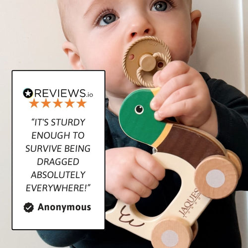 Baby holding a wooden toy with a five-star review rating on the left. 