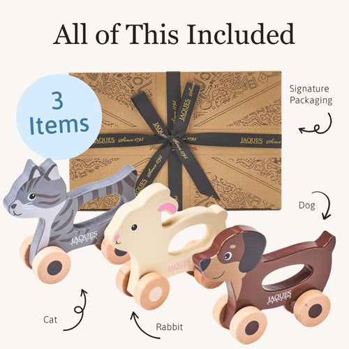 Three wooden animal push toys with packaging labelled 'All of This Included' and 'Signature Packaging'. 