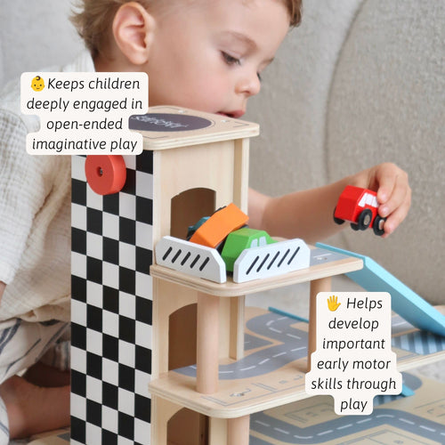 Toddler playing with a wooden toy parking garage, moving colorful cars down the ramps. 