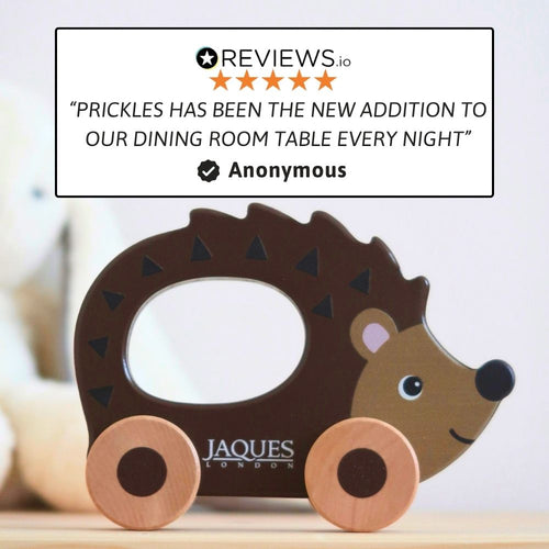 Wooden hedgehog toy with wheels and Jaques London branding, featuring a five-star review quote. 