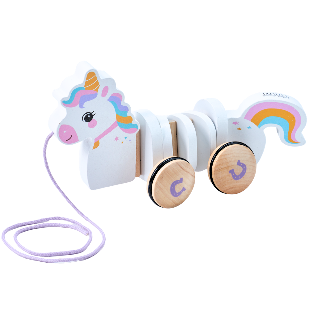 A wooden pull toy shaped like a smiling unicorn with a rainbow tail, featuring pastel-colored details and two natural wood wheels on a white background. 