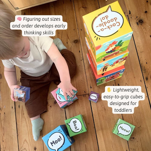 Child playing with colourful educational cubes on a wooden floor 