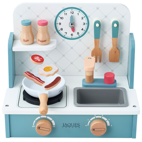 Jaques wooden toy play kitchen with a light blue and white stove, toy utensils, salt and pepper shakers, a clock, and cooking accessories, shown on a white background. [fill]