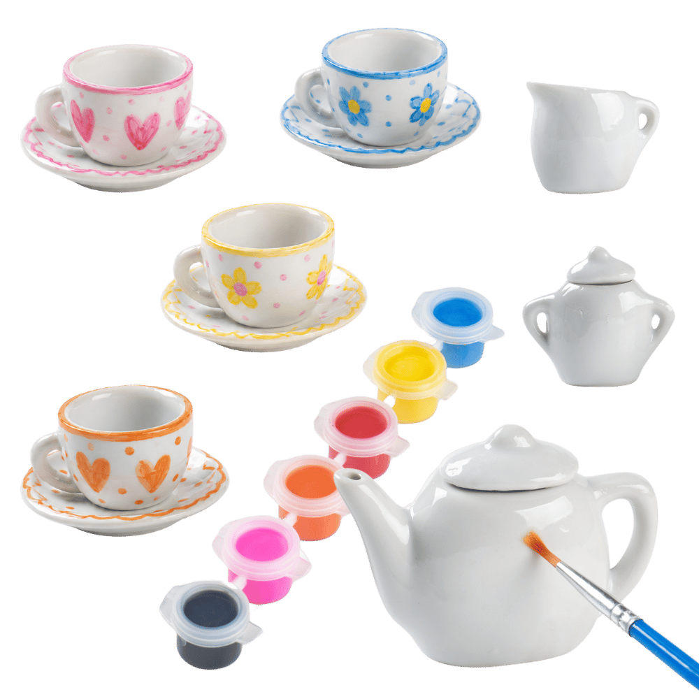 Set of miniature ceramic tea cups, saucers, and teapot with paint containers and brush on a transparent background 