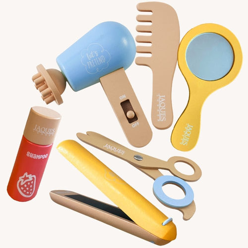 Close-up of the toy hairdryer, brush, mirror and styling tools 