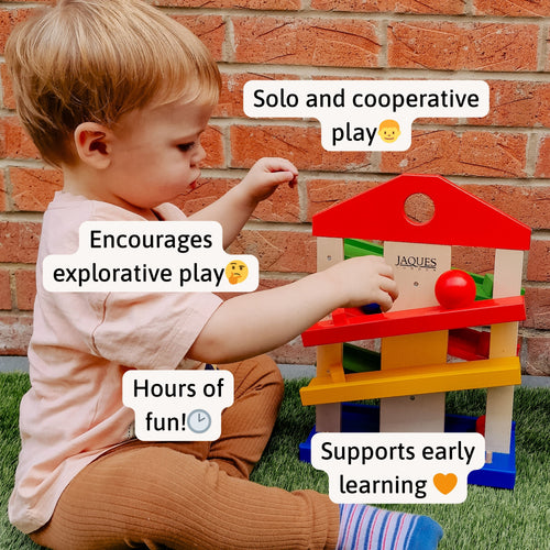 “Little boy enjoying Jaques of London wooden ramp toy outdoors – supports early learning, explorative play, and hours of engaging fun. 