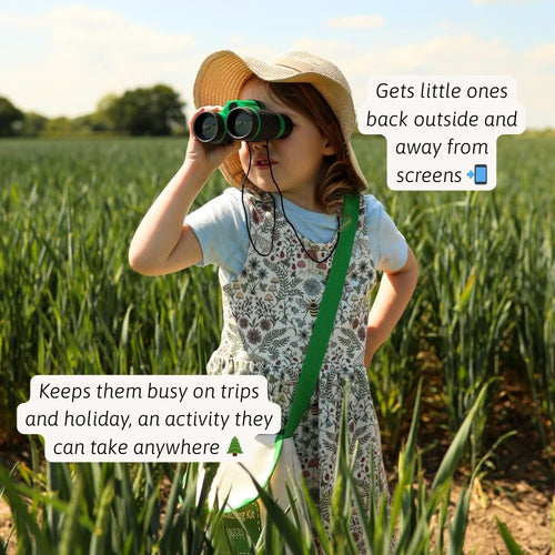 Outdoor bird watching as a child scans the trees with their binoculars 