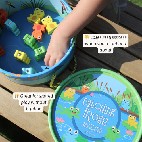Close-up of hands using a wooden fishing rod to catch wooden frogs in a blue “Let’s Climb Across the Logs” pond game, highlighting easy setup and shared play benefits 