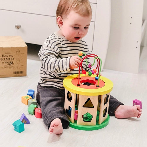  Child playing with activity cube for toddlers 