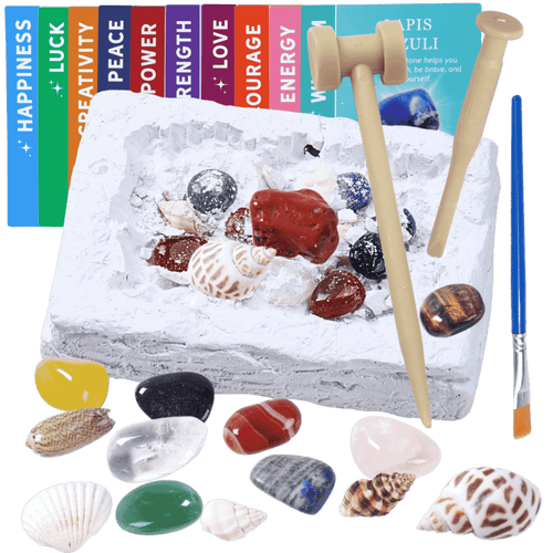 Decorative stone with seashells, stones, and a brush on a black background