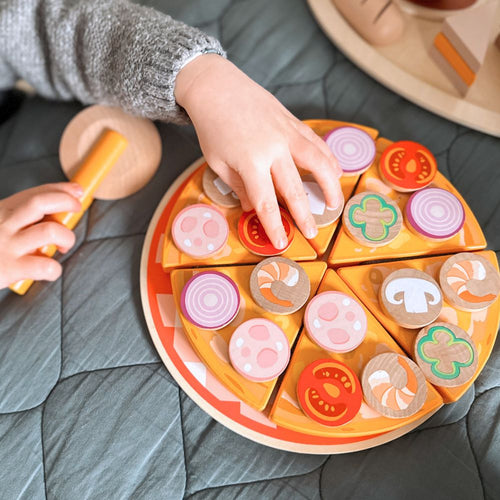  Child playing with wooden pizza toy 