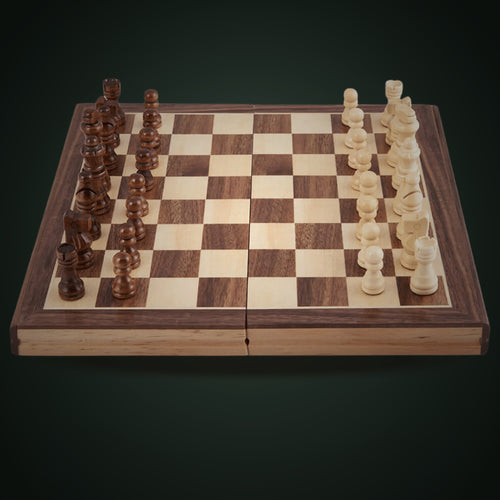 Jaques folding walnut and sycamore chess set on a deep green background 