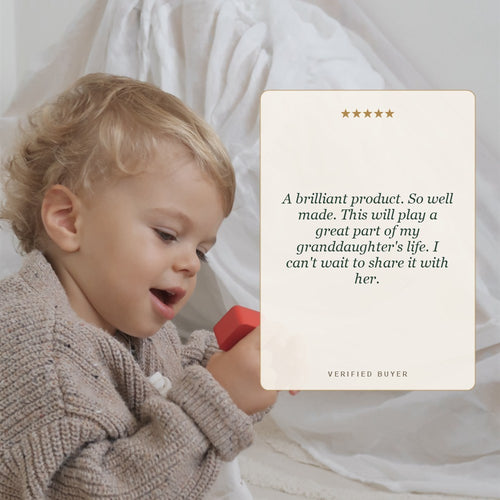 Five star customer review of the Jaques wooden teaching clock beside a toddler at play, a brilliant handmade gift 