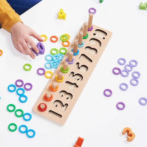   Child sorting wooden colourful numbers and rings  