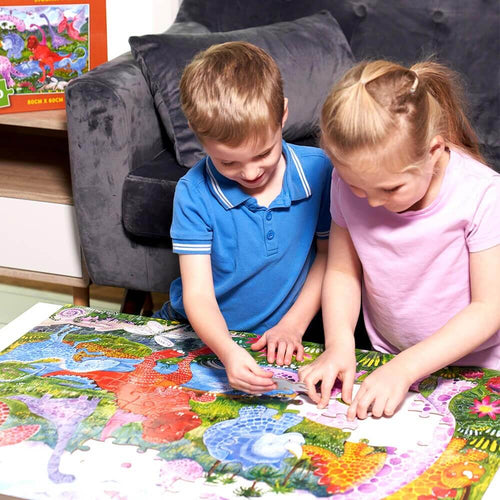   Children placing dinosaur puzzle pieces