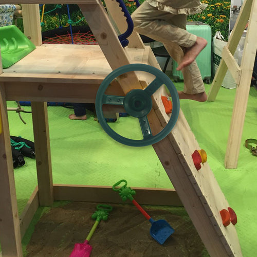 Green kids play steering wheel attached to play frame  