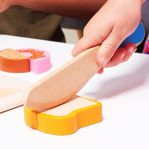  Hand pretending to slice pretend bread from bakery set