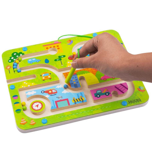Hand holding magnet to guide magnetic balls