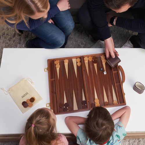  Family playing with 15 inch mahogany backgammon set 