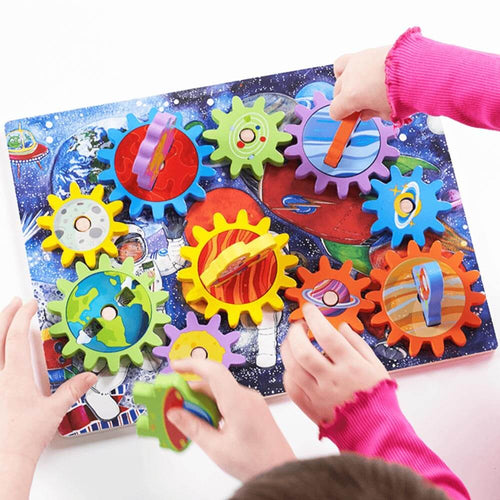 Childrens hands twisting pieces to turn cogs on space puzzle 