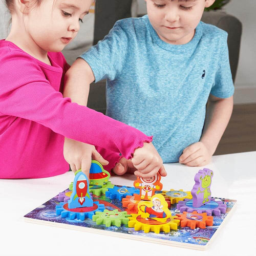 Child twisting spaceman piece to turn cogs on space puzzle  