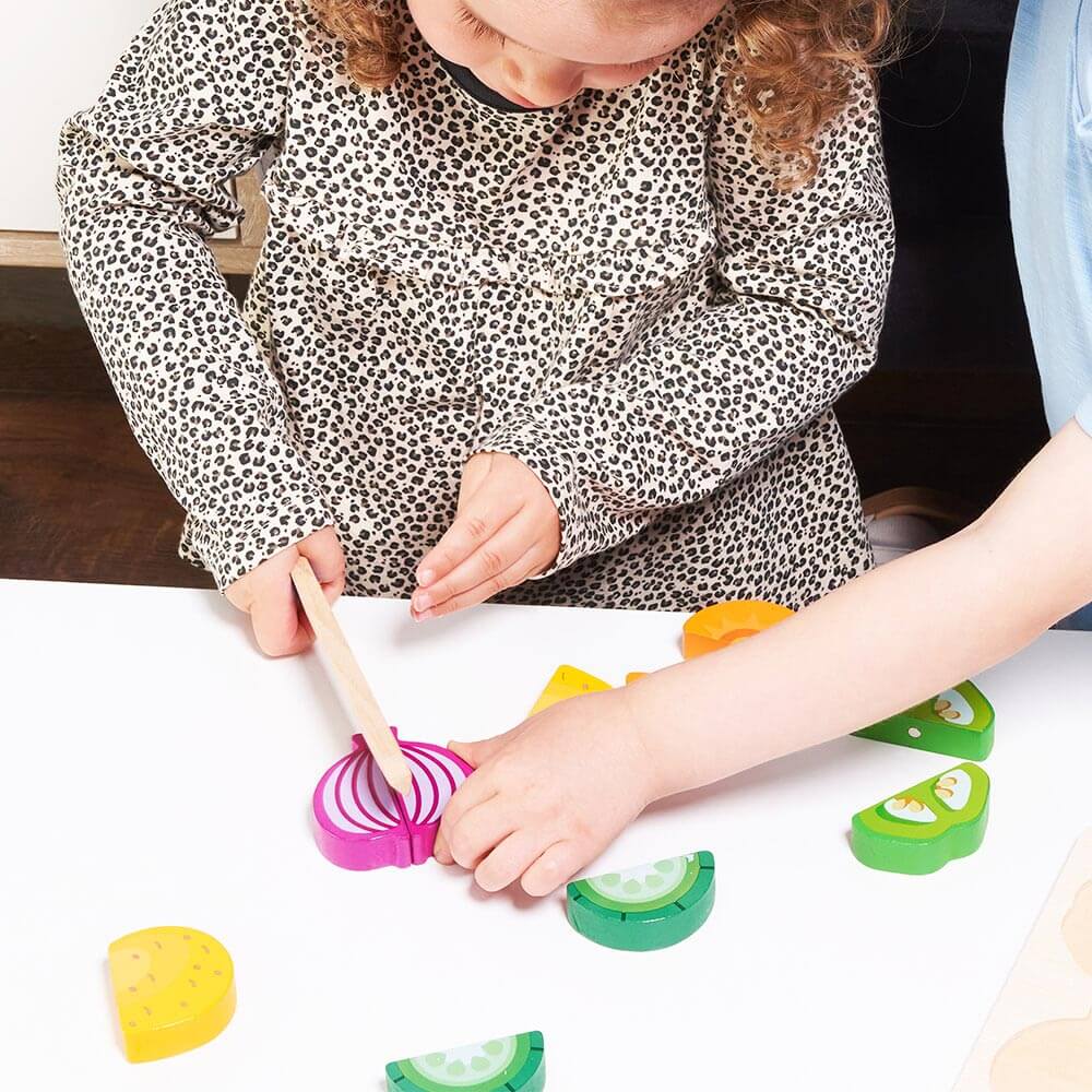  Children pretending to slice play food onion