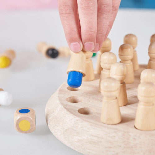  Wooden memory game - A close up of a child gripping wooden peg to reveal the colour blue 