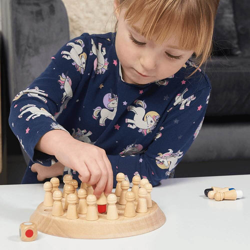  Wooden memory game - girl lifts peg to reveal red colour underneath